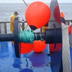 Taking the end buoys onto the net drum, before clipping in the port rope.