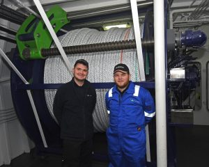 Thistle Marine engineers Alec Hay (left) and Nathan Bruce provide a scale perspective for Achieve’s self-hauling power reels.