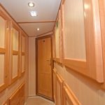 Locker and drawer storage areas are arranged either side of the passageway leading to the five-berth starboard cabin.