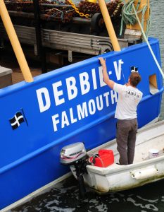 11. Skipper Tom Beresford putting the finishing touches to the paintwork.