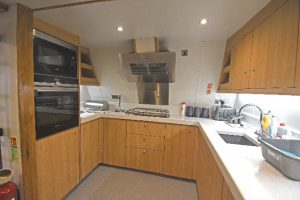 The well-equipped modern galley is arranged on the port side of the transom…