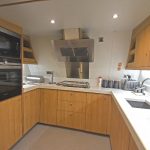 The well-equipped modern galley is arranged on the port side of the transom…