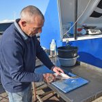 Nick Jenkins prepares fish for one of his regular customers. “Supplying fresh fish from the sea is what our business is all about.”