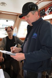 Seafish vessel surveyor Henry Millington at work, during the sea trials of the Joyful Spirit.