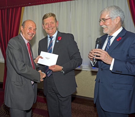 Commodore David Dickens, chief executive of the Fishermen’s Mission, presenting the second prize in the raffle to Tim Oliver. (Photo: Paul Riddell)