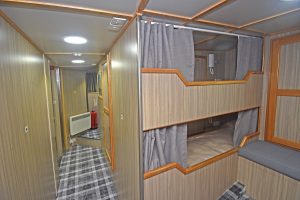 Two of the five beds arranged to port in the full-width accommodation cabin.
