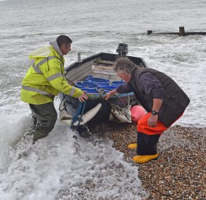 Mike Harvey helps Selsey fisherman Dave Robinson bring his tender ashore, after being at sea for 10 hours on his Holton 24 Betty Peerley…