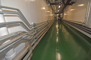 … from which pipes run to the forward system, and vice versa, to give full duplication at all times. The insulated recycled hot water pipes are on the starboard side of the passageway.