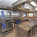 Meals for a crew of 32 are prepared in the stainless-steel galley…
