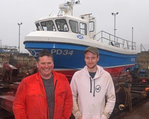 Arbroath skipper Tommy Yule and his son Tommy prepare to take Onward S off Peterhead slipway, before starting to fish from Arbroath.