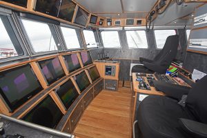 The wheelhouse is arranged to give easy access between the port and starboard fishing consoles.