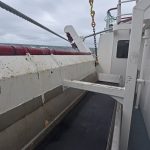 Wide catch conveyors positioned along the full length of the working deck…