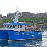 Leah III heading out of Boddam harbour after dropping off a keeper of brown crab.