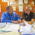 Roger Gee discusses the MCA inspection report, hands over the new logbook and goes over final paperwork, before signing off on the survey with Holly Anne co-owner Sean Irvine.