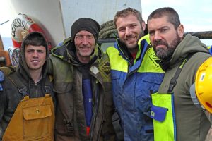 Genesis crewman Phil Watt and mate/relief skipper Jamie Gordon with Ben Cohen and Shane Lynch.