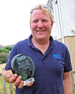 Cornish Sardine Management Association chairman Gus Caslake holding the MSC award.