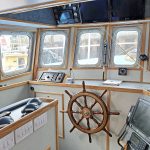 The wheelhouse has been finished in bright laminate with oak edging trim.