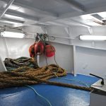The previously open foredeck is now enclosed by a whaleback and serves as a storage area.