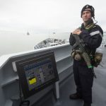 AB (Sea) Lee Bolton providing force protection on HMS Tyne as she leaves Portsmouth.