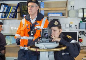 Operations officer Lt Emily Witcher navigating HMS Tyne through the deepwater channel, with the pilot overseeing the operation.