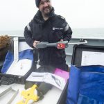 LET (CIS) Harry Perks holding the Omega mesh gauge that is used for checking fishing nets.