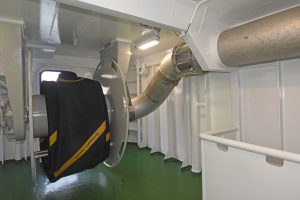 A pump-through hydraulic hose reel connected to the overhead stainless steel delivery pipe is mounted on the shelterdeck.