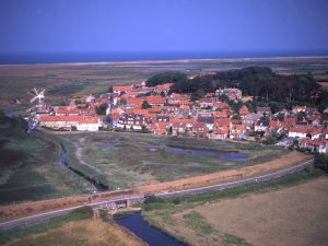 The village of Cley, just downstream of the bank that spelled the end for the Glaven ports – along the line of which the coast road now runs.