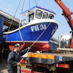 Skipper Daniel Gilbert guiding the Girl Dee Dee on to the lorry ahead of her recent launch at Newlyn.