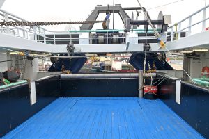 A hydraulically operated gate is positioned between the stern ramp and the central hatch leading to the catch reception hopper.