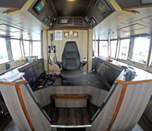 The skipper’s chair, flanked by screens on both sides.