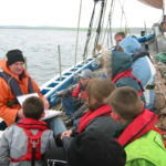 Andrew Halcrow teaches pupils about the Swan on a school trip in 2003.