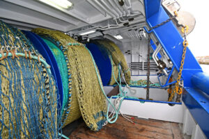 Two sets of split net drums are mounted on the hardwood-planked quarter.