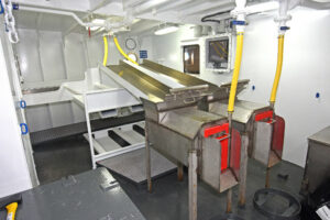 Drop-in chutes are used to deliver gutted fish directly into two washers.