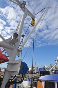 Auxiliary tipping winches and short derricks are fitted towards the top of the Scotch poles.